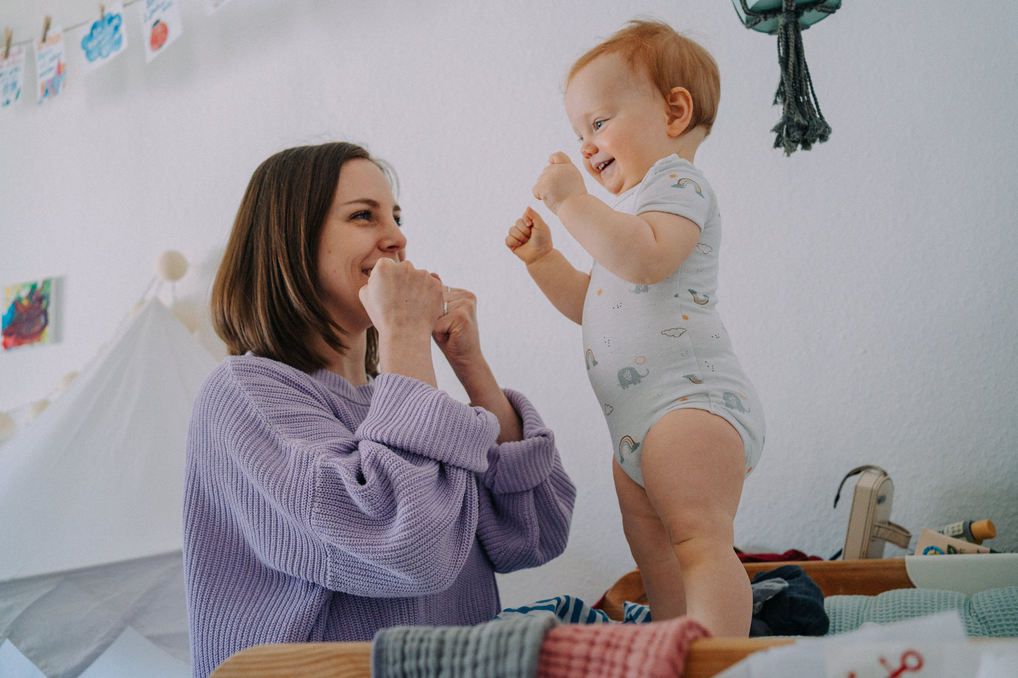 Mama und Baby spielen auf Bett – innige Verbindung Mutter-Kind Fotografie